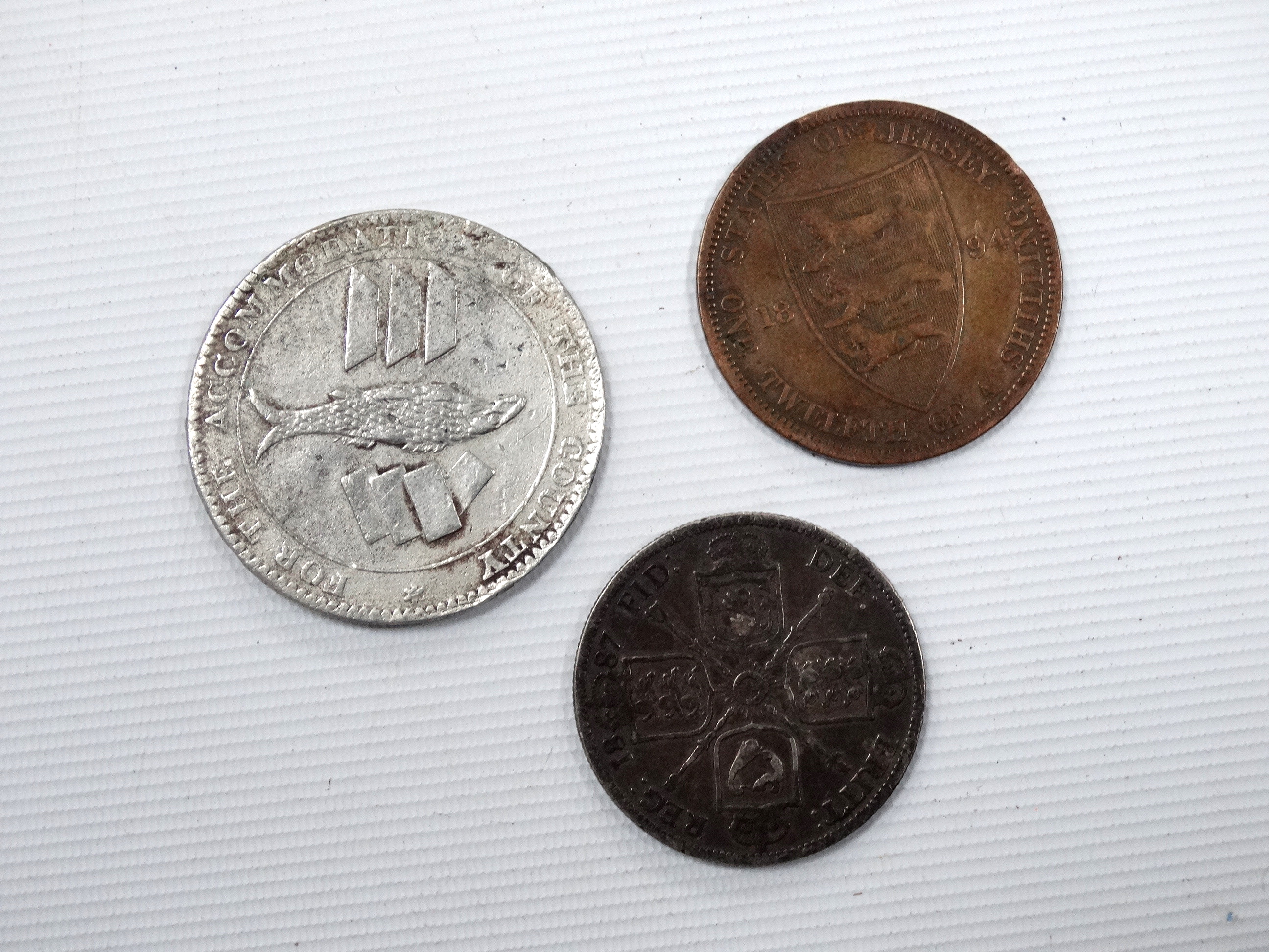 A silver Cornish penny 1811 - together with a 1887 Victoria silver florin and a Jersey 1894 1/20th