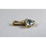 A 9ct gold pendant - set a trillion cut aquamarine, weight 1.8g.