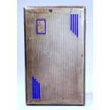 A silver cigarette case - Chester 1932, of rectangular form, engine turned with blue Art Deco