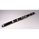 An ebony flute by H.Y. Potter & Co. - length 38cm.
