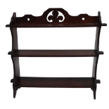 An Edwardian mahogany book shelf - of wedged construction, with three tiers and a pierced gallery