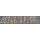 An Indian printed runner - with geometric design in blue and yellow, 327 x 79cm.