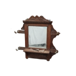A late Victorian carved oak hall mirror - with bevelled rectangular central plate above a shelf