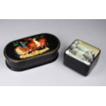 Two 20th century Russian black lacquer painted hinge lidded boxes - one painted with a troika to the