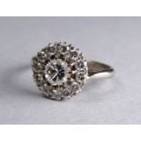 A diamond dress ring - the central stone approx. 0.5ct within a band of diamonds twelve smaller,