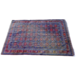 An Indo Persian fine wool hand knotted rug - with an arrangement of forty five madder guls on a blue