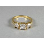 A three stone dress ring - square cut in claw setting, marked 14k, size N, weight 2.4g.