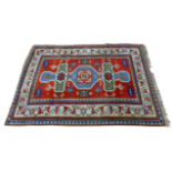 A Turkish Konya rug - with central geometric medallion on a madder ground within a multi panel