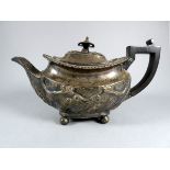 A Silver teapot - London 1897, oval with repousse swag decoration and ebony fittings, on ball