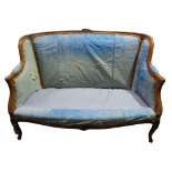 An early 20th century Louis XVI style walnut framed upholstered sofa - carved with flower buds and