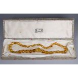 A possibly citrine graduated faceted bead necklace with gold clasp - the largest circular bead