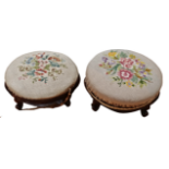 A pair of Victorian mahogany foot stools - circular with gross point embroidered upholstery and