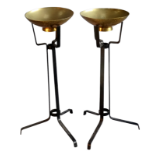 A pair of brass and wrought iron torchieres - with dished bowls on tripod wrought iron supports,