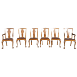 Six George II style walnut dining chairs - including two with arms, with vase shaped splats and