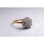 A cubic zirconia dress ring - the multi stone floral setting on a yellow metal band, size O,