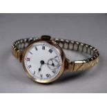 An early 20th century ladies yellow gold cased wristwatch - 9ct, the white enamel dial set out in