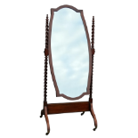 An early 20th century mahogany cheval mirror - the broadly oval plate between spiral twist