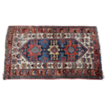 An Anatolian rug - the central cobalt medallion on a white ground with stylised bird design and