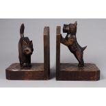 A pair of early 20th century Black Forest bookends - modelled in the form of Scottie dogs and cat on