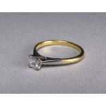 A solitaire diamond ring - the stone claw set in platinum on an 18ct yellow gold band, 2.4g, size