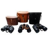 A pair of Greenkat field glasses - 10x50, in a tan leather case, together with two other pairs of