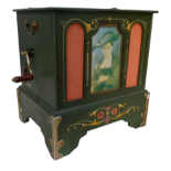 A green painted table top barrel organ - the case detailed with scrolls and foliate decoration,