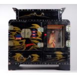 A 20th century Japanese black lacquer table cabinet - decorated with landscape scenes, incorporating