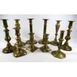 A pair of 19th century brass candlesticks - with reeded columns on circular bases, height 23cm,