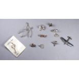 A quantity of silver and white metal charms - including aircraft, a train, old boots and a fire
