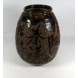 A 20th century Chinese stoneware vase - the speckled treacle glaze decorated with character marks,