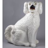 A late 19th century Staffordshire dog - in a seated pose with gilt decoration, height 33cm.