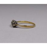 A three stone diamond ring - set in an 18ct yellow gold band, size P/Q, weight 2.9g.