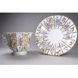 A late 19th century continental cup and saucer - of an exaggerated size and decorated with panels of