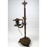 An early 20th century brass bouillotte table lamp - with a reeded column and cast circular base
