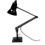 A Herbert Terry anglepoise lamp - black painted on a stepped square base.