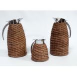 A pair of stainless steel vacuum flasks - bound in wicker and of 1.8 litre capacity, together with