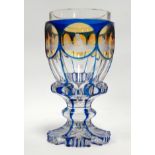 A mid 19th century Bohemian flash cut goblet - in blue and amber, engraved with scenes of a