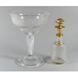 An early 19th century clear glass comport - the rim etched with grapes and leaves, raised on a