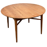 A 20th century Danish pine circular dining table - on turned legs joined by an X-shaped stretcher,
