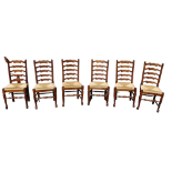 A set of six George III style ash and oak ladder back chairs - with rush seats and peripheral