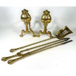 A pair of brass Arts and Crafts andirons - of stylised flower bud form, height 30cm, together with a