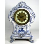 A late 19th Delft mantel clock - incorporating vignettes of Dutch scenes, the cream dial set out
