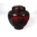 A 20th century cinnabar and black lacquer ginger jar - decorated with panels of flowers on a red