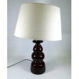 A large West German mid century pottery table lamp - of turned baluster form in a dark treacle