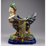 A 19th century Palissy style spoon warmer modelled as a siren - standing on a rectangular base