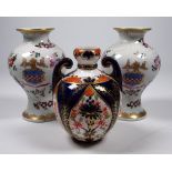 A Royal Crown Derby Imari pattern vase - of bellied form with twin handles, height 10cm, together