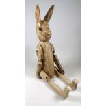 A 20th century carved wood articulated bunny - distressed white paintwork, height 68cm.
