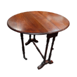 An Edwardian walnut drop leaf Sutherland table - the oval top above twin turned legs width 60cm,