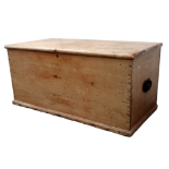 A late 19th century pine trunk - the hinged top above dovetailed carcass and steel bale handles,