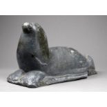 A 20th century Inuit soapstone carving of a seal - length 25cm.